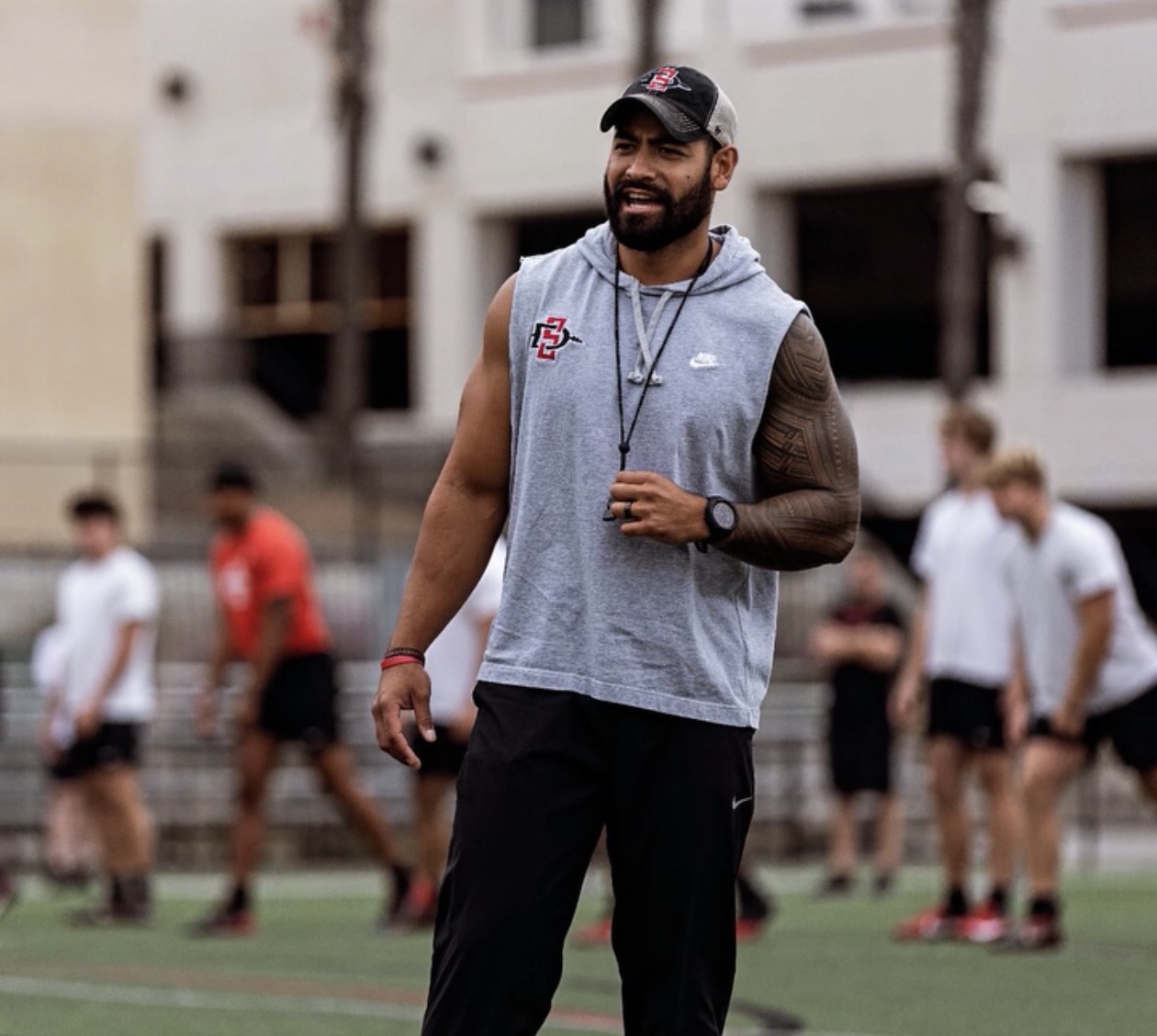 Coach G leading a field training session with athletes